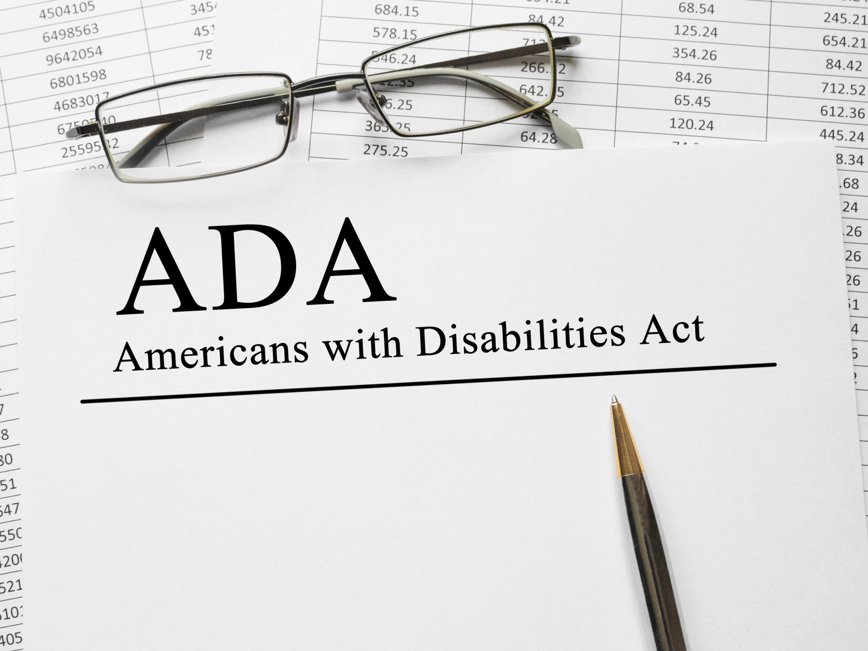 Paper with Americans with Disabilities Act (ADA) on a table