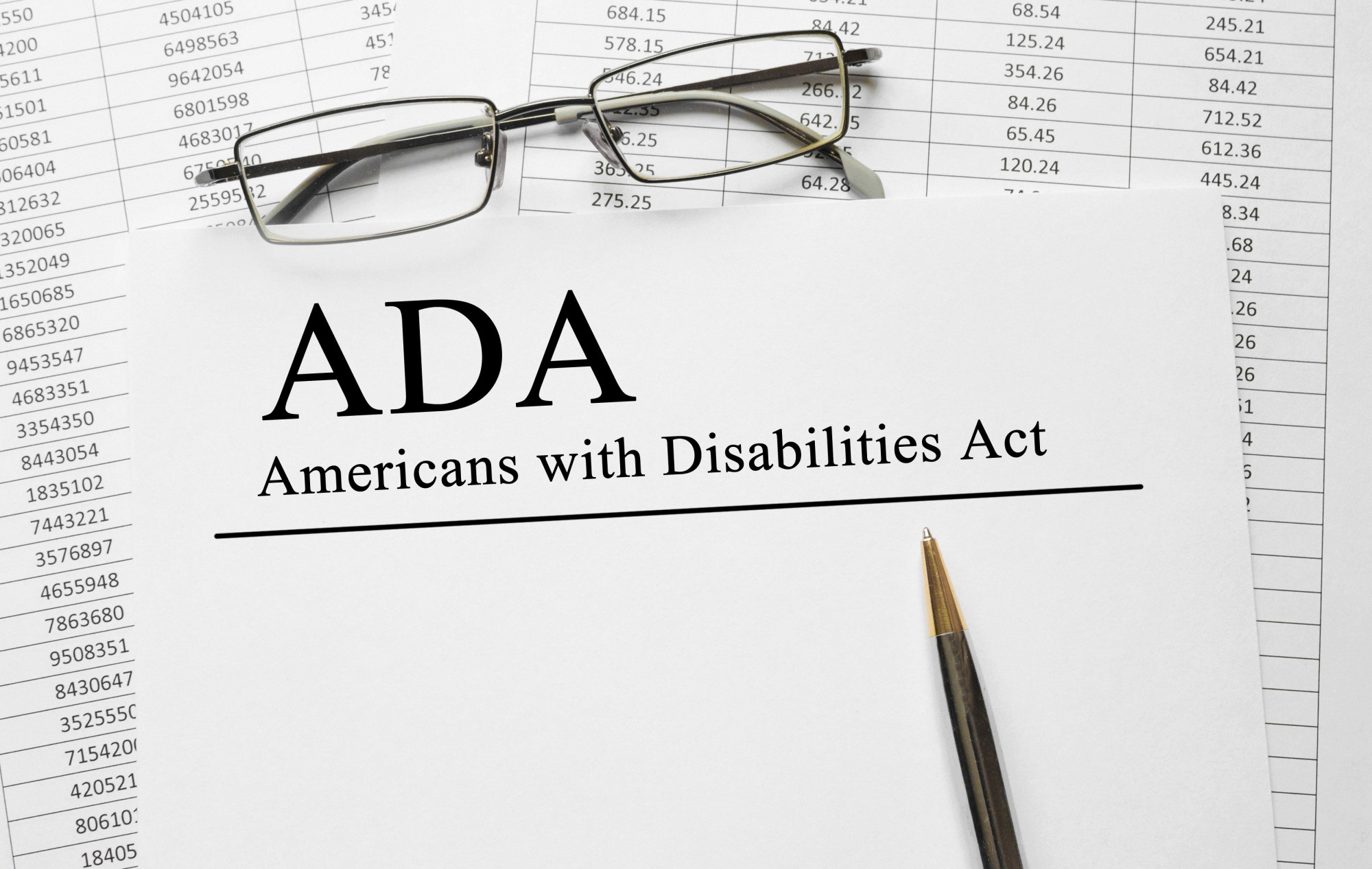Paper with Americans with Disabilities Act (ADA) on a table